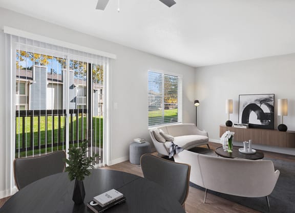 Model Dining/Living Room with Wood-Style Flooring and Patio Accessibility at Overlook Point Apartments in Salt Lake City, UT.