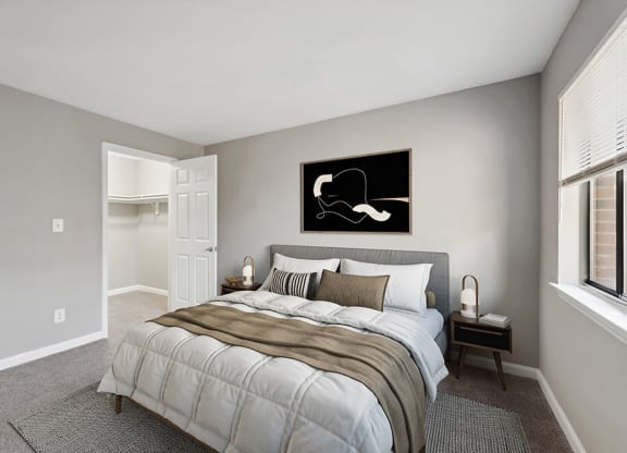 Model Bedroom with Carpet and Walk In Closet at Spring Forest Apartments in Raleigh, NC.
