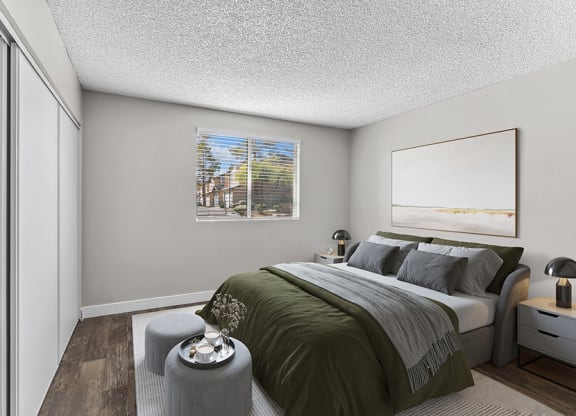 Model Bedroom with Wood-Style Flooring at Meadow Ridge Apartments in Las Vegas, NV.