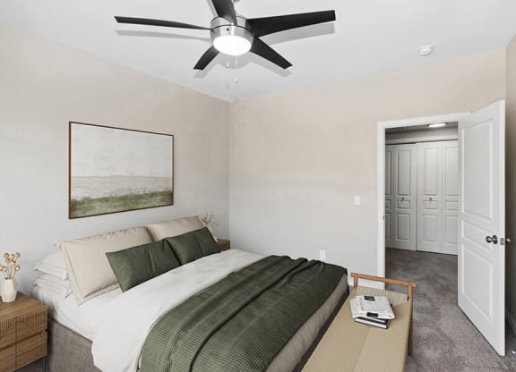 Model Bedroom with Carpet and Hallway View at Belmont at Duck Creek Apartments in Garland, TX.