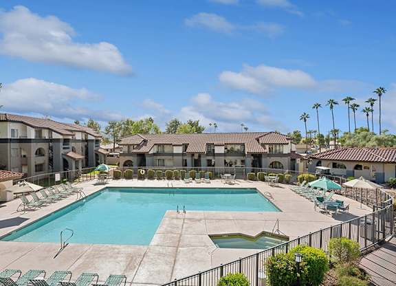 Community Swimming Pool with Pool Furniture at Stillwater Apartments located in Glendale, AZ.