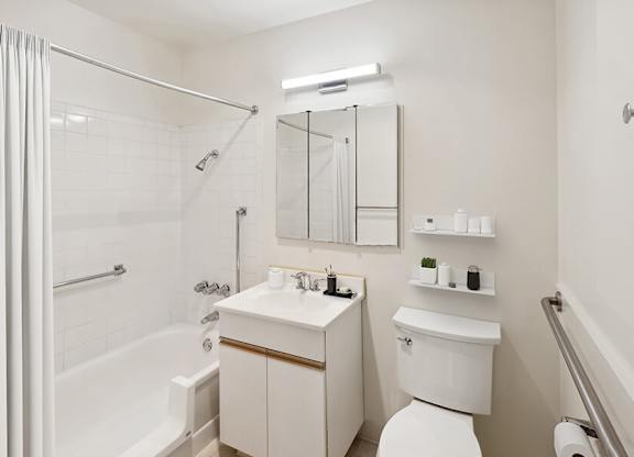 Model Bathroom with White Cabinets, Wood-Style Flooring & Shower/Tub at Walnut Creek Apartments located in Walnut Creek, CA.