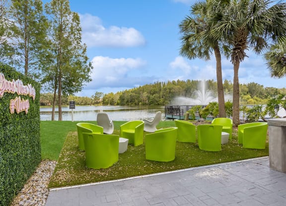 Outdoor lounge area with a fountain in the background and palm trees in the foreground