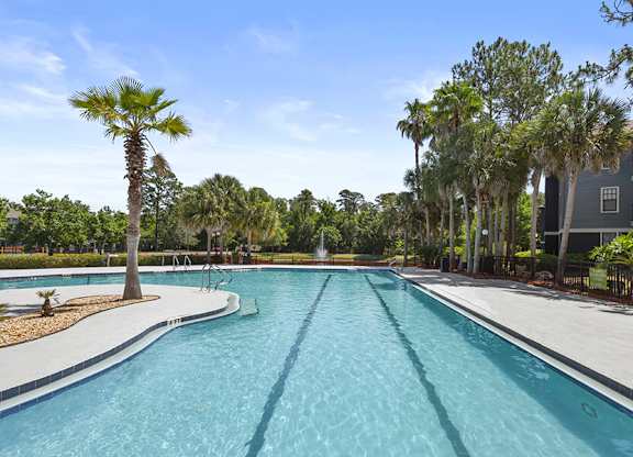 Community Swimming Pool with Pool Furniture at Mirage on Kernan Apartments located in Jacksonville, FL.