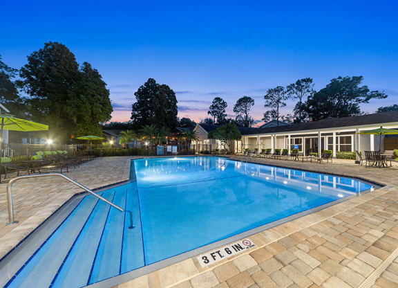 Community Swimming Pool with Pool Furniture at Retreat at Crosstown Apartments in Riverview, FL.