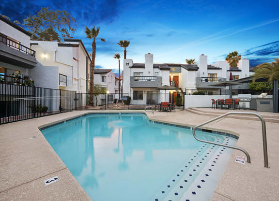 Community Swimming Pool with Pool Furniture at Crystal Creek Apartments in Phoenix, AZ.