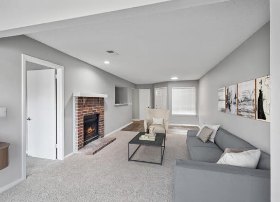 Model Living Room with Carpet and Patio Accessibility at Abbington Heights Apartments in Antioch, TN.
