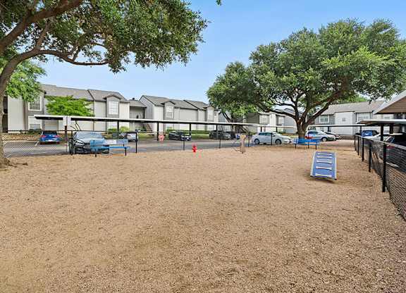 Community Dog Park with Agility Equipment at Cobblestone Apartments located in Arlington, TX.