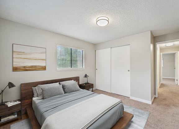 Model Bedroom with Carpet and Closet at Grammercy Apartments located in Renton, WA.