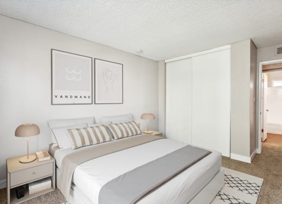 Model bedroom with a bed and two night stands