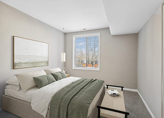 Model Bedroom with Carpet and Window View at Spring Parc Apartments in Silver Spring, MD.