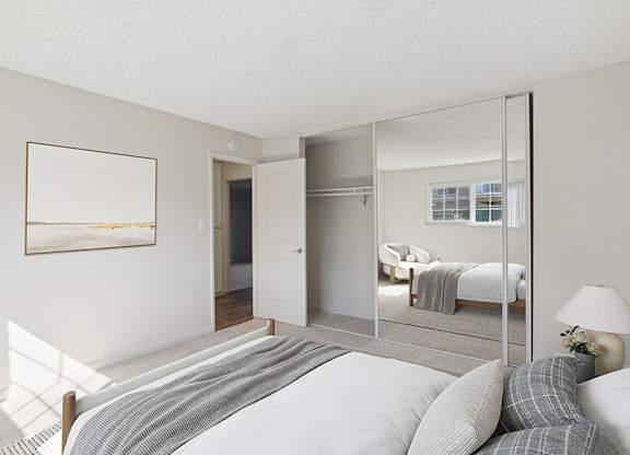 Model Bedroom with Carpet and Large Closet at Los Gatos Landing Apartments located in San Jose, CA.