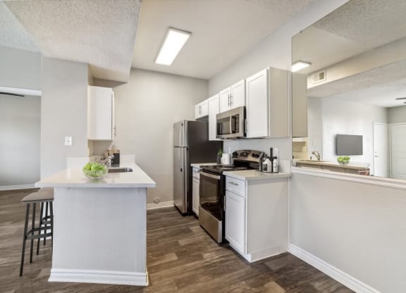 a kitchen with a stove top oven next to a refrigerator