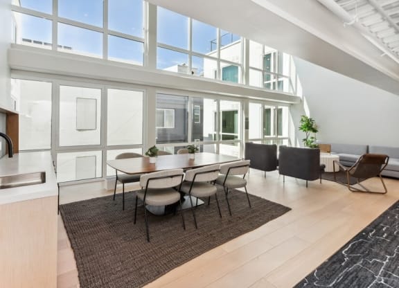 Community kitchen space with large sun windows at TL Residences