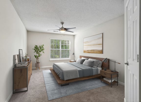 Model Bedroom with Carpet and Window View at Retreat at Stonecrest Apartments located in Lithonia, GA.