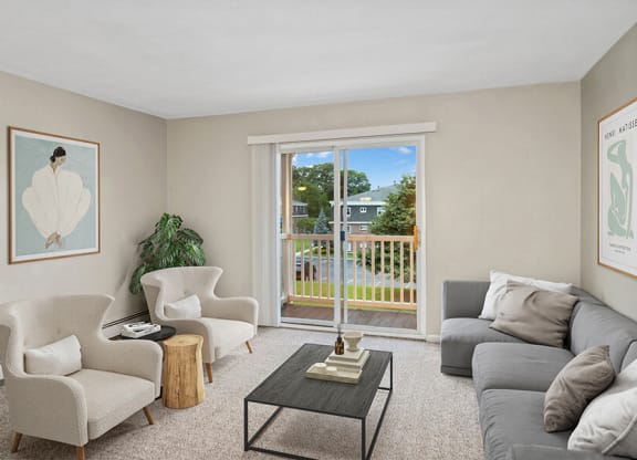 Model living room with a sliding glass door  at Stone Ends apartments in Stoughton, MA