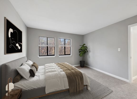 Model Bedroom with Carpet and Hallway View at Spring Forest Apartments in Raleigh, NC.