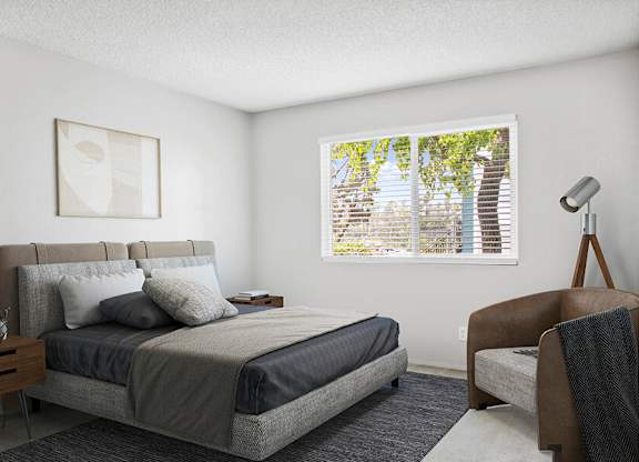 Model Bedroom with Carpet and Window View at Cove La Mesa Apartments located in La Mesa, CA.