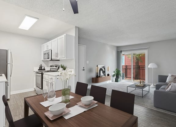 Model Living Room with Wood-Style Flooring and View of Kitchen/Living Room Area at The Archer Apartments in Sacramento, CA.