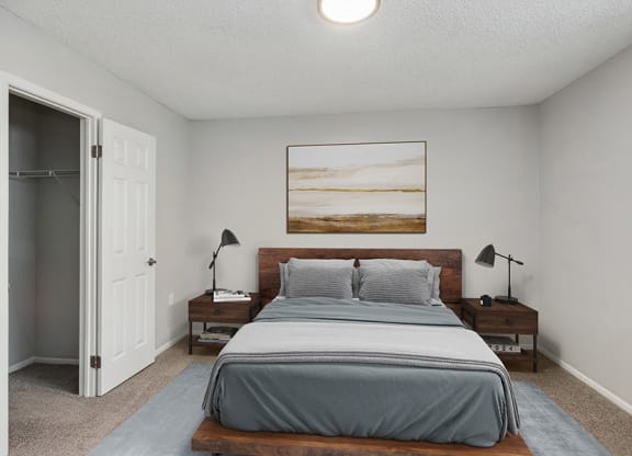 Model Bedroom with Carpet and Closet at Parc at Creekside Apartments in Kansas City, MO.