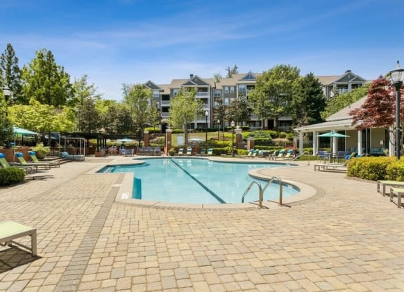 Swimming pool with cabanas and lounge chairs
