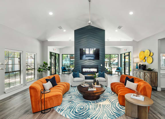 Community Clubhouse with Lounge Furniture and Fireplace at Bridges at Deer Run Apartments in Dallas, TX.