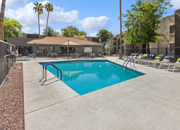 Community Swimming Pool with Pool Furniture at Saddle Ridge Apartments in Tucson, AZ.