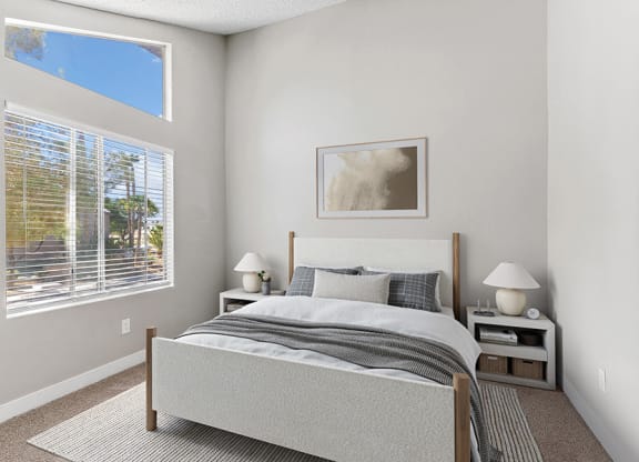 Model Bedroom with Carpet and Window View at Meadow Ridge Apartments in Las Vegas, NV.