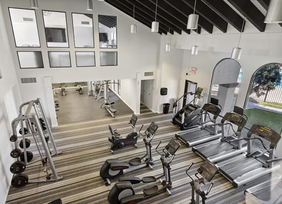 Community Fitness Center with Equipment at Hilands Apartments in Tucson, AZ.