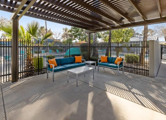 A covered patio with two couches and a coffee table at Lakeside Casitas in Tucson, AZ