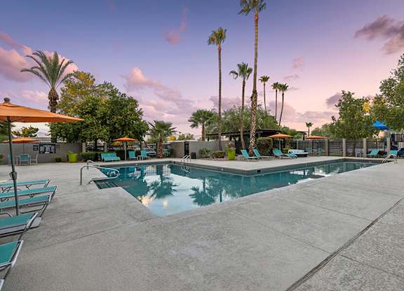 Community Swimming Pool with Pool Furniture at Lakeside Casitas Apartments located in Tucson, AZ.
