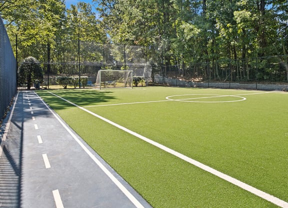 Community Soccer Field with Nets and Walking Path at Arbor Village Apartments located in Charlotte, NC.