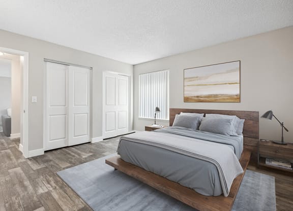 Model Bedroom with Wood-Style Flooring and attached Bathroom at Peaks on 4th Apartments in Avondale, AZ.