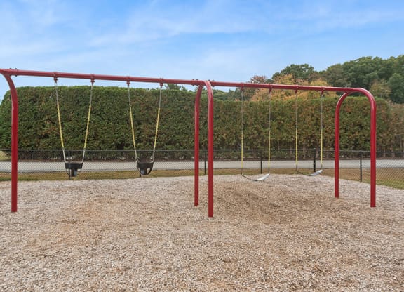 Community Swing Set at Meadows at Marlborough Apartments located in Marlborough, MA.