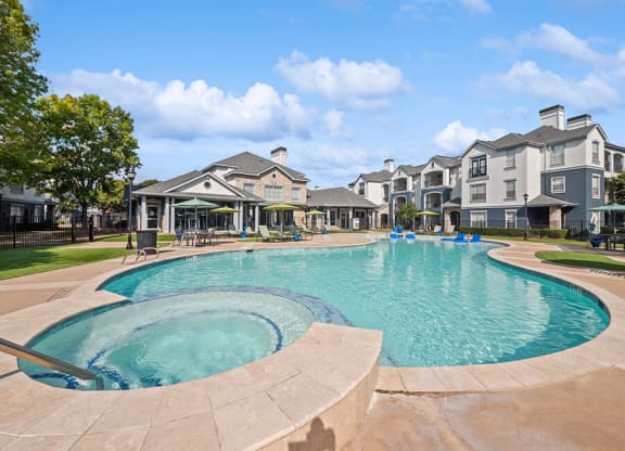 Community Swimming Pool and Hot Tub at Park West Apartments located in Houston, TX.
