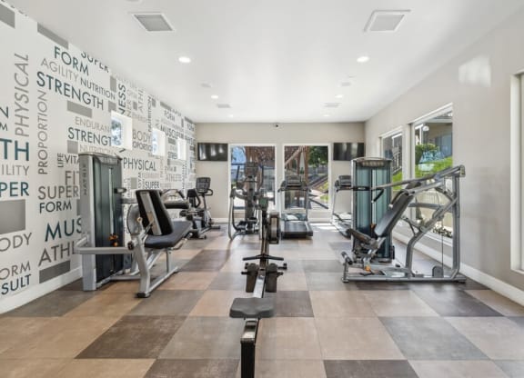 Community Fitness Center with Equipment & Window View at Forest Park Apartments in El Cajon, CA.