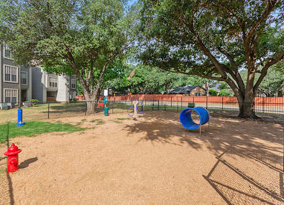 Community Dog Park with Agility Equipment at Cobblestone Apartments located in Arlington, TX.