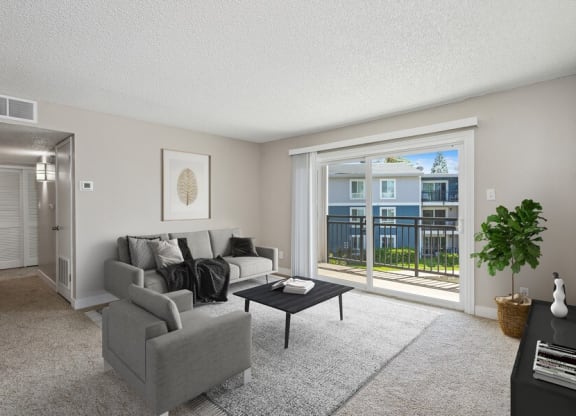 Model living room with a sliding glass door leading to a balcony
