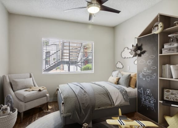 a bedroom with a bed and a chair in front of a window