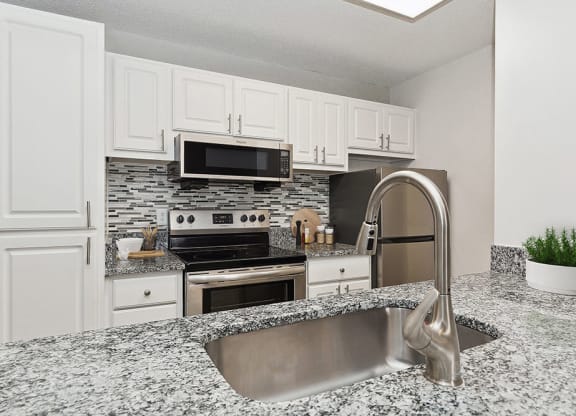 Model Kitchen with White Cabinets at Seven Lakes at Carrollwood Apartments in Tampa, FL.