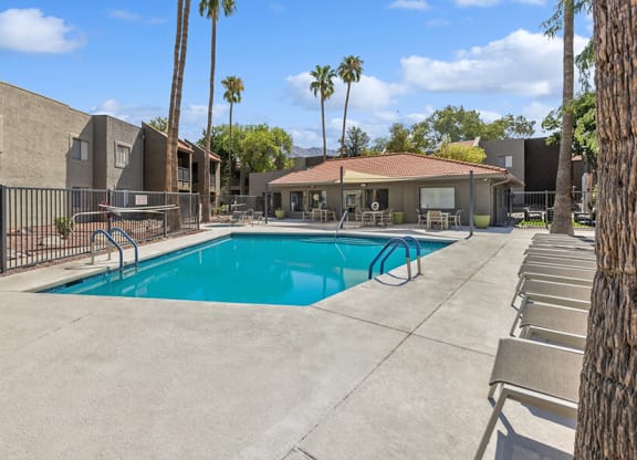 Community Swimming Pool with Pool Furniture at Saddle Ridge Apartments in Tucson, AZ.