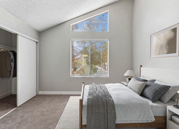 Model Bedroom with Carpet and Closet at Meadow Ridge Apartments in Las Vegas, NV.