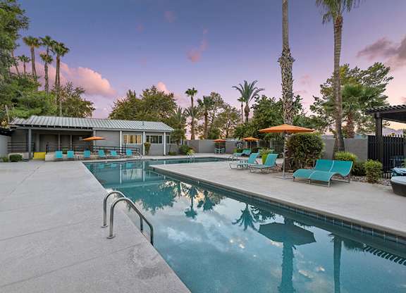 Community Swimming Pool with Pool Furniture at Lakeside Casitas Apartments located in Tucson, AZ.