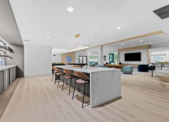 A modern kitchen with a long table and chairs.