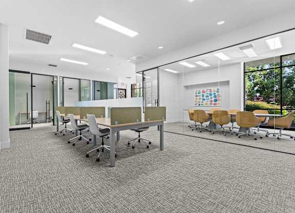 A conference room with a long table and chairs.
