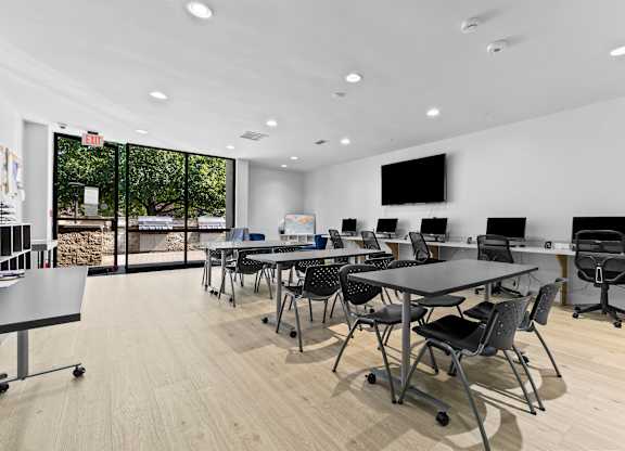A conference room with a long table and chairs.