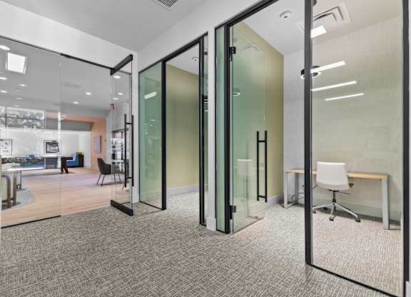 A glass wall separates two rooms.