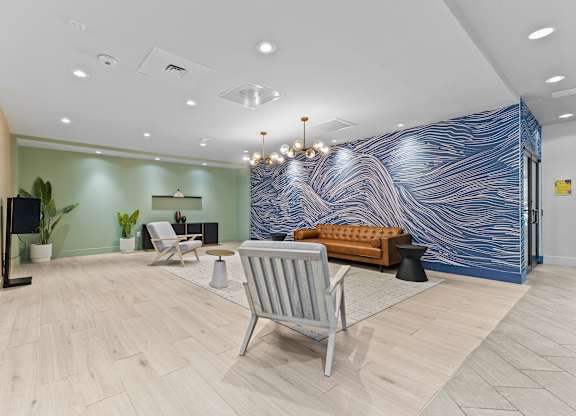 A blue and white marbled wall in a room with a chair and a table.