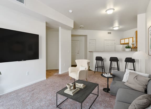 Model Living Room with Carpet and View of Kitchen at Altitude on Fifth Apartments in Salt Lake City, UT.