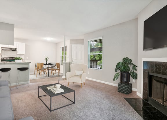 Model Living Room with Carpet, Fireplace and View of Kitchen at Park 2300 Apartments in Charlotte, NC.
